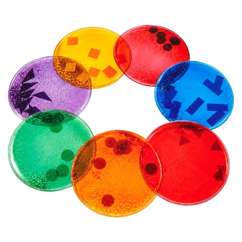 MTA Essentials Giant Squidgy Sparkle Circles Tactile Set of 7 displayed against a clean white background. The large 19cm translucent circles appear in assorted purple, yellow, red, blue, green and orange tones with glittery liquid and floating geometric shapes clearly visible inside.