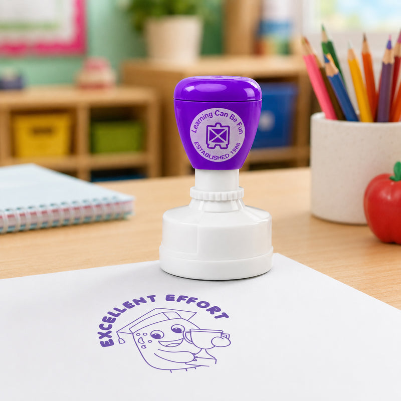 Learning Can Be Fun Excellent Effort reward stamp positioned on a worksheet in a bright educational setting. The bold purple stamped design stands out clearly, showcasing the fun character illustration and motivational message used by teachers to celebrate student effort.