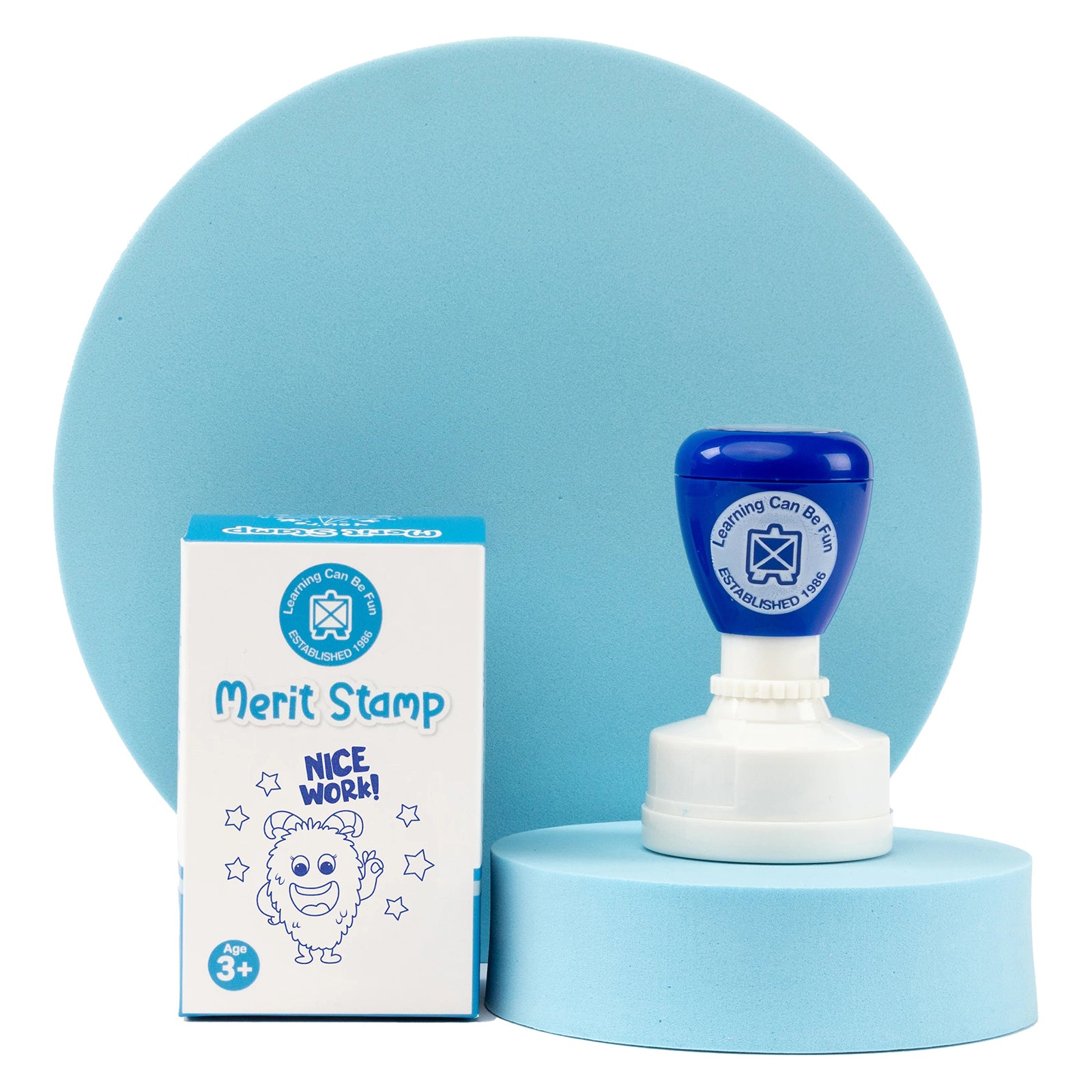 Retail packaging and self inking Nice Work merit stamp displayed against a soft blue presentation backdrop. The packaging showcases the cheerful reward theme while highlighting the compact and practical design for everyday classroom use.