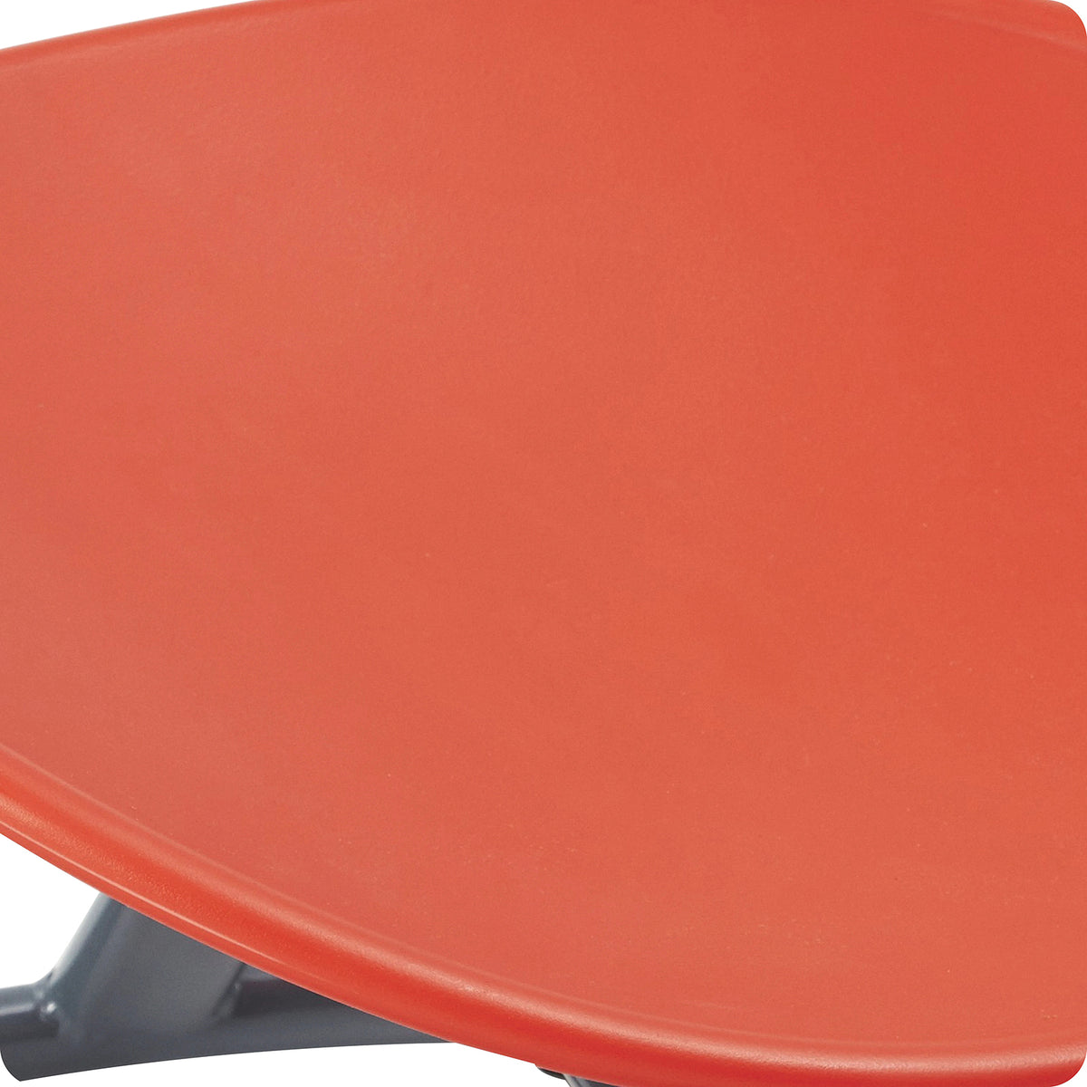 Detailed close view of the red moulded Gonge Balance Disc seat, showing the smooth seating surface and substantial raised outer edge. The enlarged product detail highlights the construction and grippable rim that gives children a convenient place to hold during supervised spinning and balance activities.