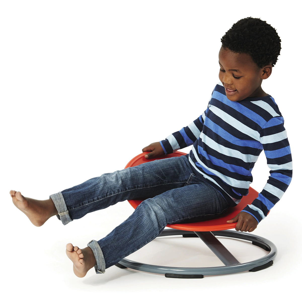 Child using the Gonge Balance Disc against a plain white background, seated on the angled red surface while holding the edge and extending both legs. The image demonstrates a typical active seated position and shows how children can use body movement and their feet while exploring balance and controlled rotation.