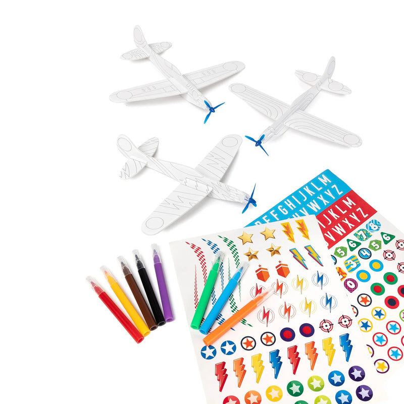 Three unassembled foam glider templates are displayed with decorative sticker sheets and coloured markers against a clean background. The image emphasises the customisation options and creative design possibilities.