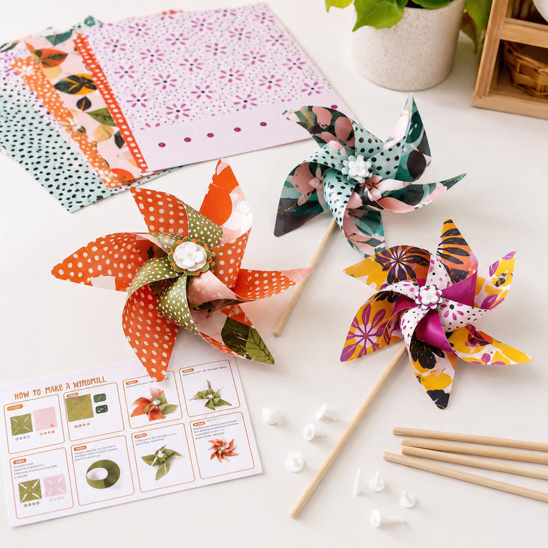A tabletop arrangement showcases three assembled windmills in different decorative patterns with included assembly components and template sheets nearby. The image emphasises the variety of designs available and the classroom friendly nature of the craft activity.