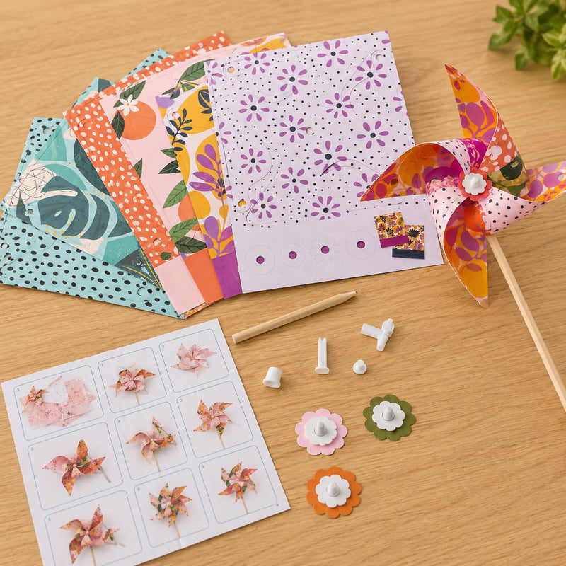 A completed floral windmill is displayed beside the decorative template sheets, assembly components and illustrated instruction guide. The image showcases the premium printed artwork and easy to follow construction system.
