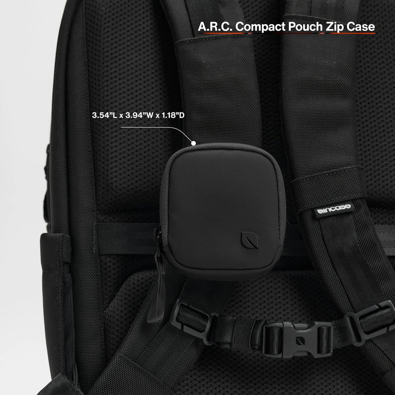 Black A.R.C. Compact Pouch clipped to a backpack shoulder strap, with the product name and dimensions printed over the image