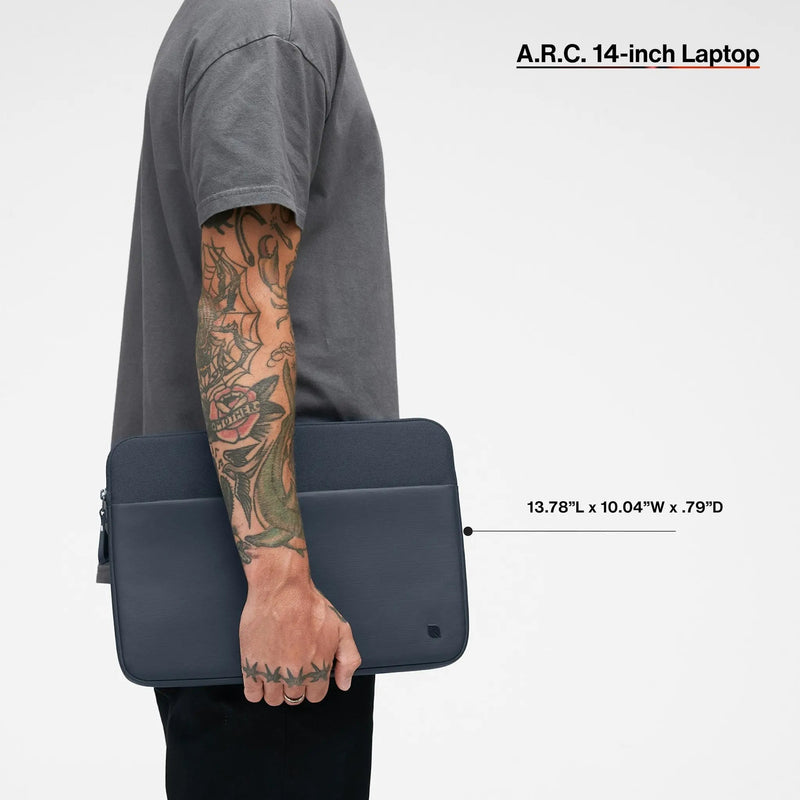 Navy A.R.C. 14-inch sleeve carried under the arm by a model, with the product name and dimensions printed over the image