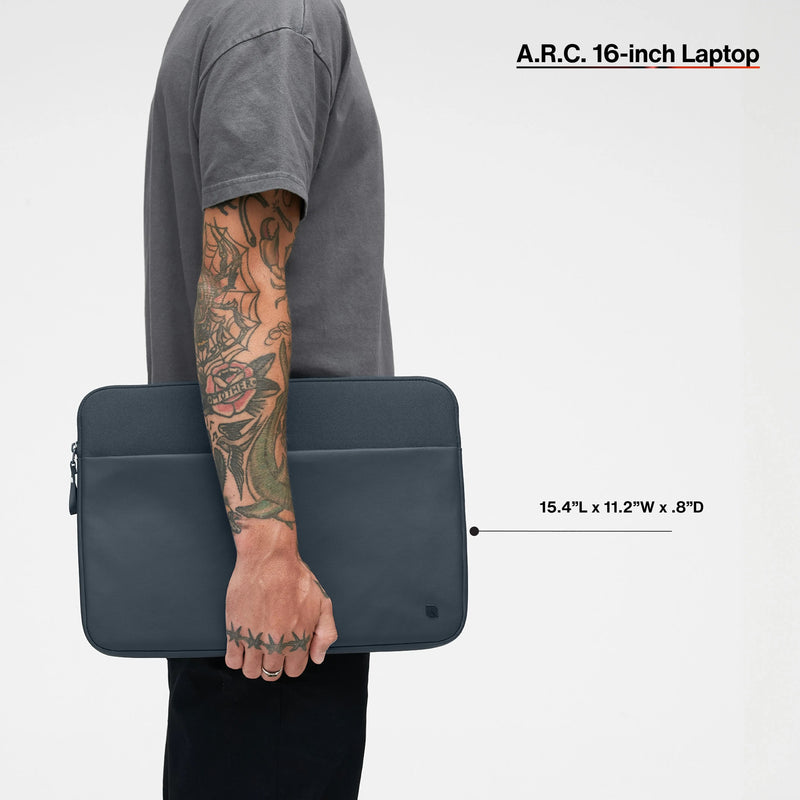 Navy A.R.C. 16-inch sleeve carried by a model, with the product name and dimensions printed over the image