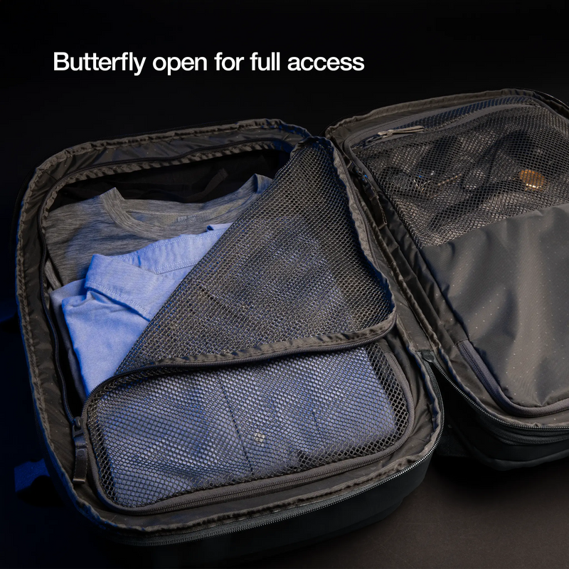 Incase A.R.C. Travel Pack opened flat butterfly-style with packed clothes in its mesh compartments, captioned Butterfly open for full access