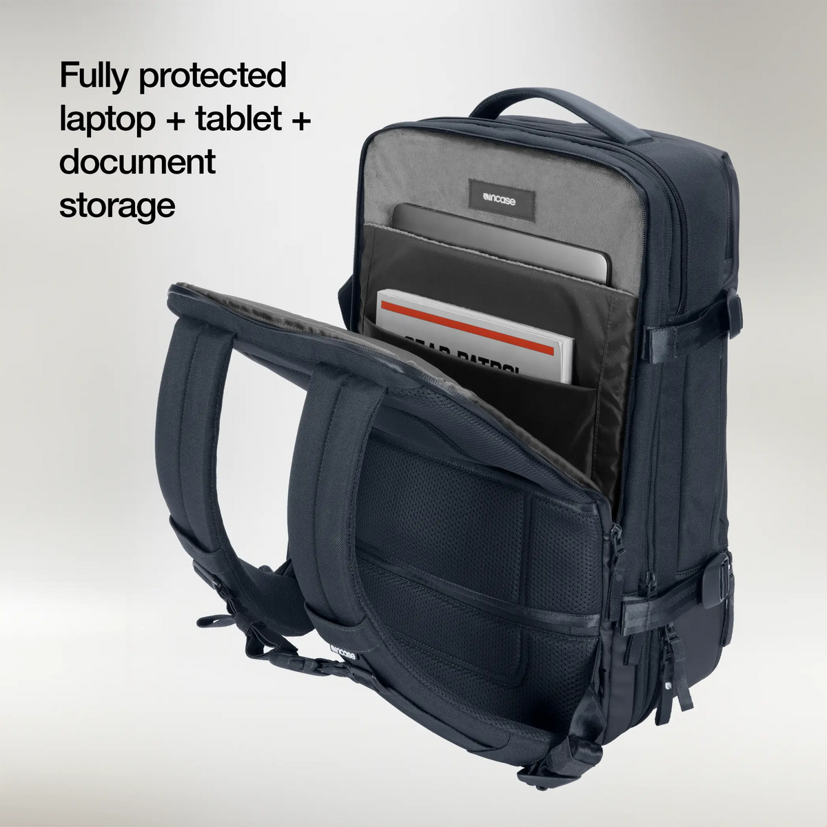 Open laptop compartment of the navy Incase A.R.C. Travel Pack holding a laptop, tablet and documents in separate sleeves