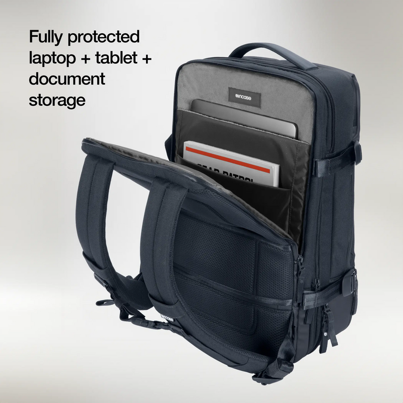 Open laptop compartment of the navy Incase A.R.C. Travel Pack holding a laptop, tablet and documents in separate sleeves