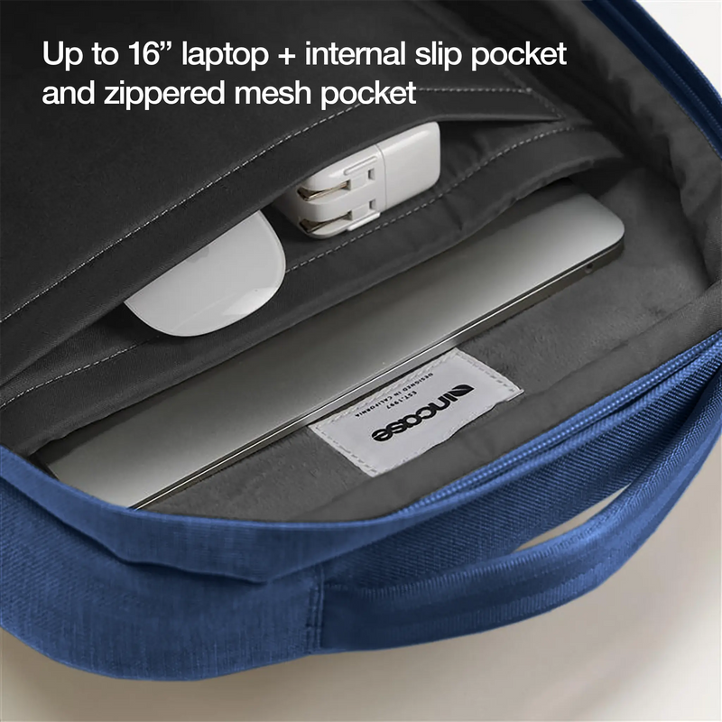 Open Crosstown Backpack showing a laptop and accessories inside, with the caption Up to 16 inch laptop plus internal slip pocket and zippered mesh pocket