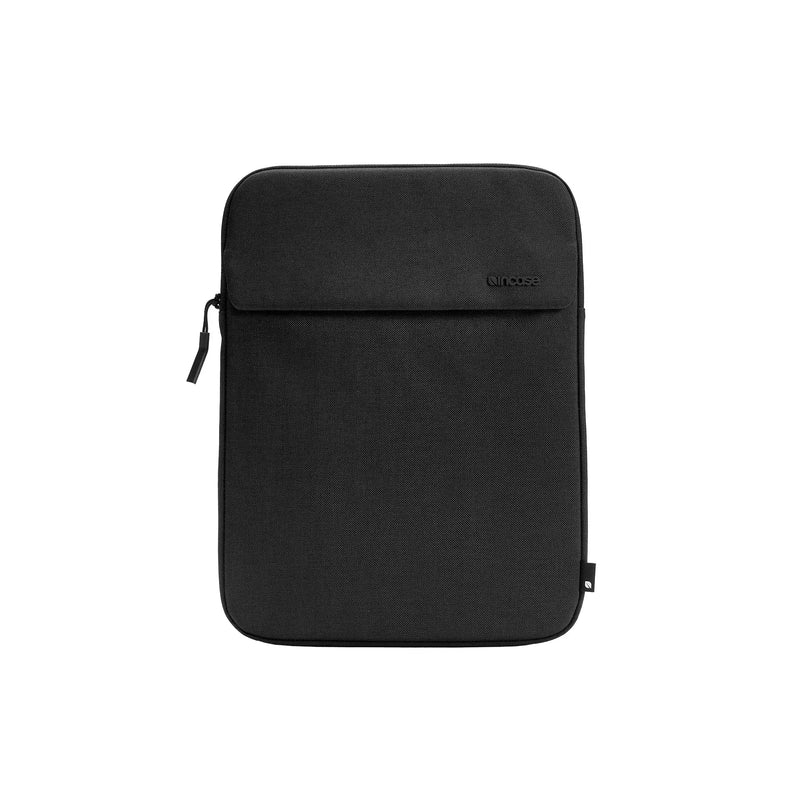 Front of the black Crosstown 14-inch sleeve showing the external slip pocket with its flap, on a white background