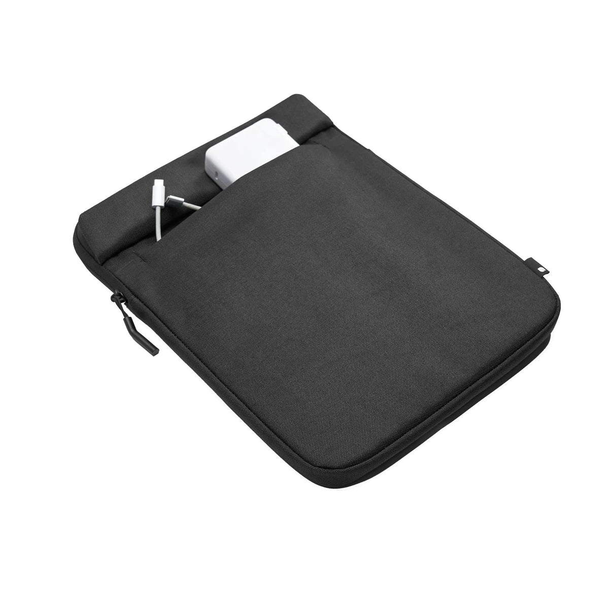 Black Crosstown 14-inch sleeve lying at an angle with a charger tucked into the front slip pocket