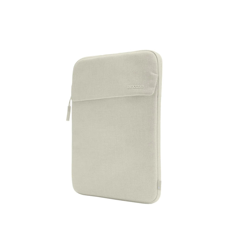 Incase Crosstown Sleeve for 14-inch laptops in Limestone, a light beige-grey, standing upright at a three-quarter angle on a plain white background