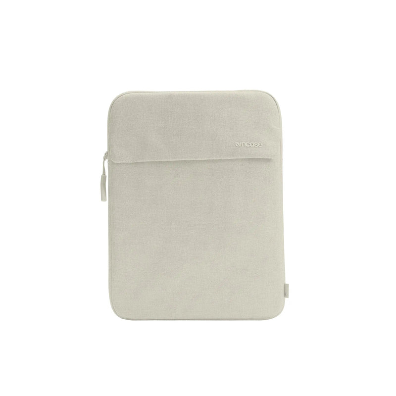 Front of the Limestone Crosstown 14-inch sleeve showing the external slip pocket with its flap, on a plain white background