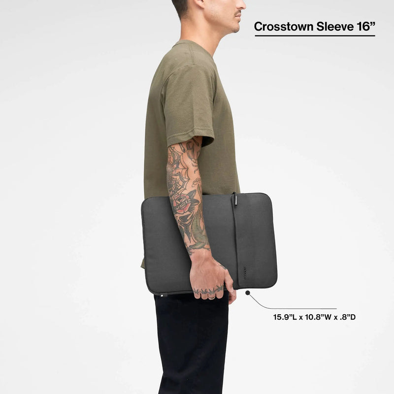 Black Crosstown 16-inch sleeve carried by a model, with the product name and dimensions printed over the image