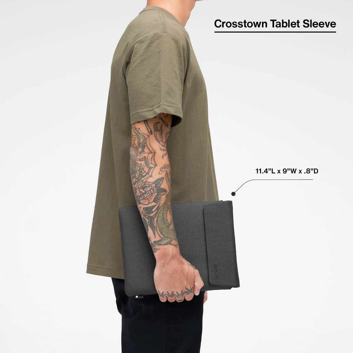 Black Crosstown tablet sleeve carried by a model, with the product name and dimensions printed over the image