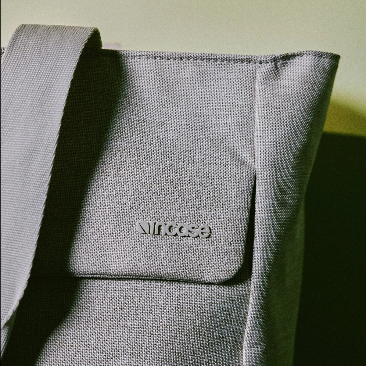 Close-up of the Limestone Woolenex fabric on the Crosstown Tote with the embossed Incase logo