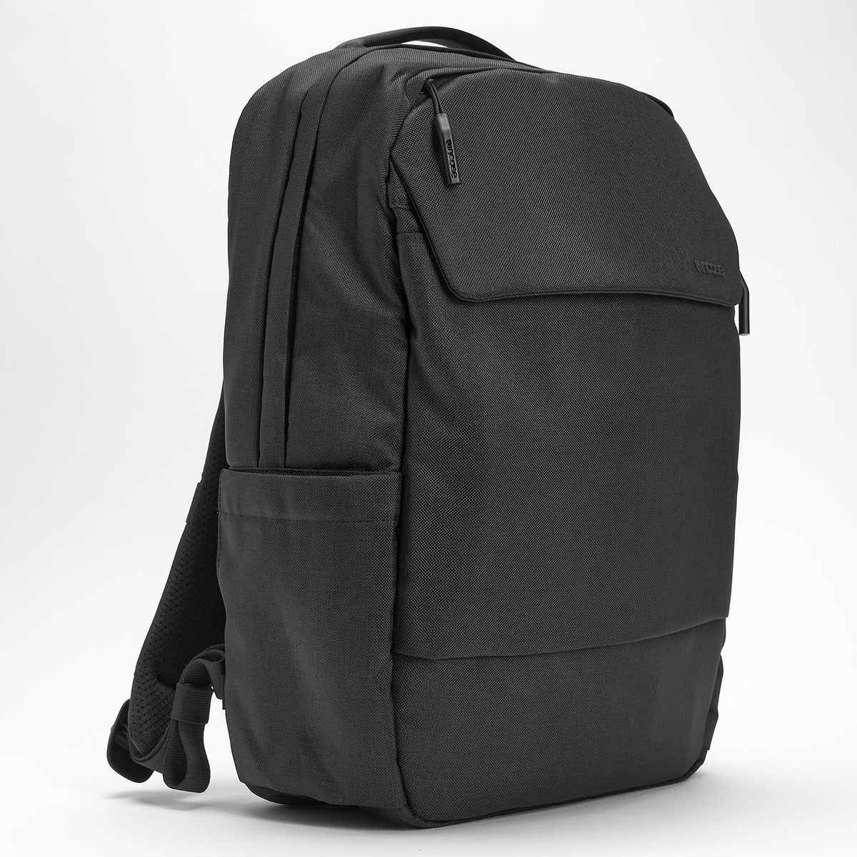 Three quarter front angle displaying the magnetic front pocket, premium zipper pulls, structured design and durable Woolenex fabric with modern minimalist styling.