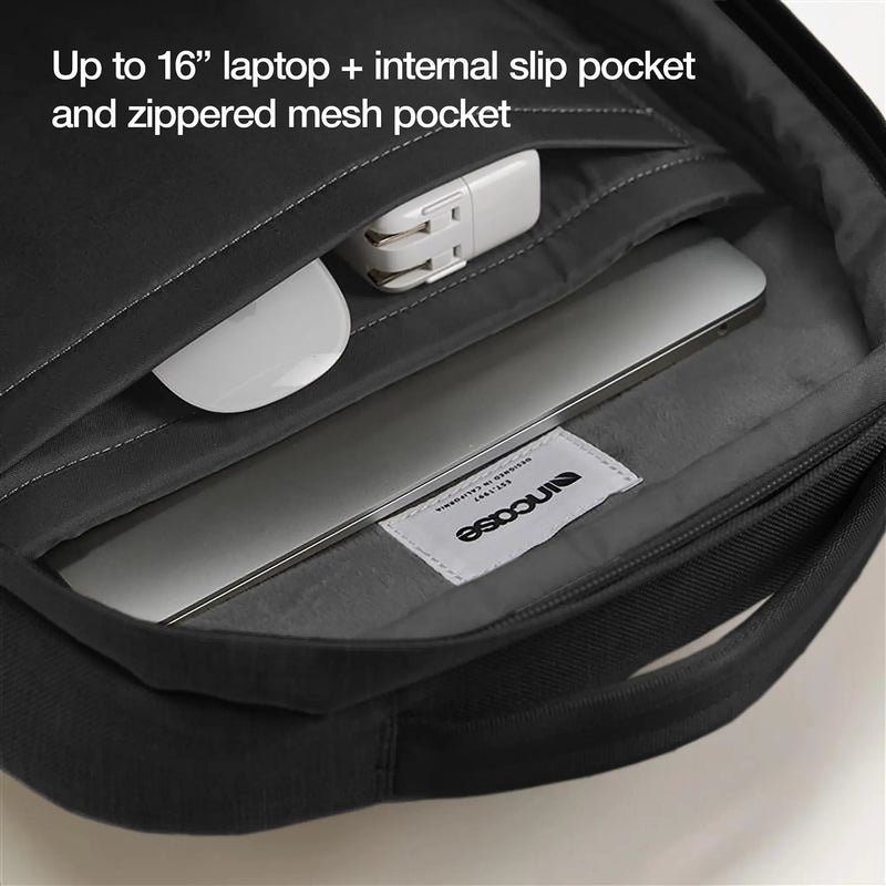 Interior view of the main compartment displaying the padded faux fur laptop sleeve, internal slip pocket and zippered mesh organiser. A 16 inch laptop and charging accessories demonstrate organised storage.