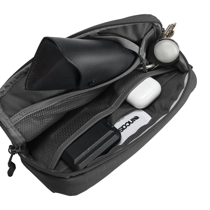 Interior view of the Incase Crosstown Sling Black displaying mesh organiser pockets, storage space for glasses, earbuds, keys, accessories and other everyday essentials arranged neatly inside.