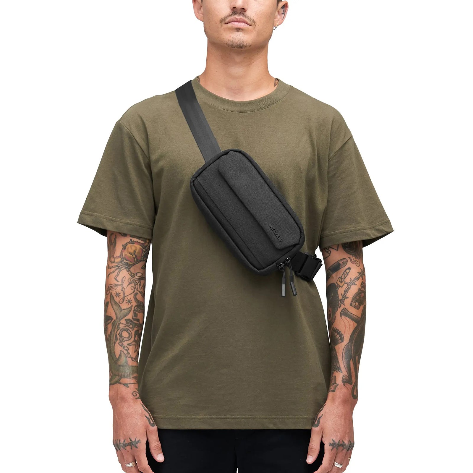 Clean front model photograph displaying how the sling sits naturally across the chest using the adjustable shoulder strap. The minimalist styling demonstrates its suitability for casual daily wear.
