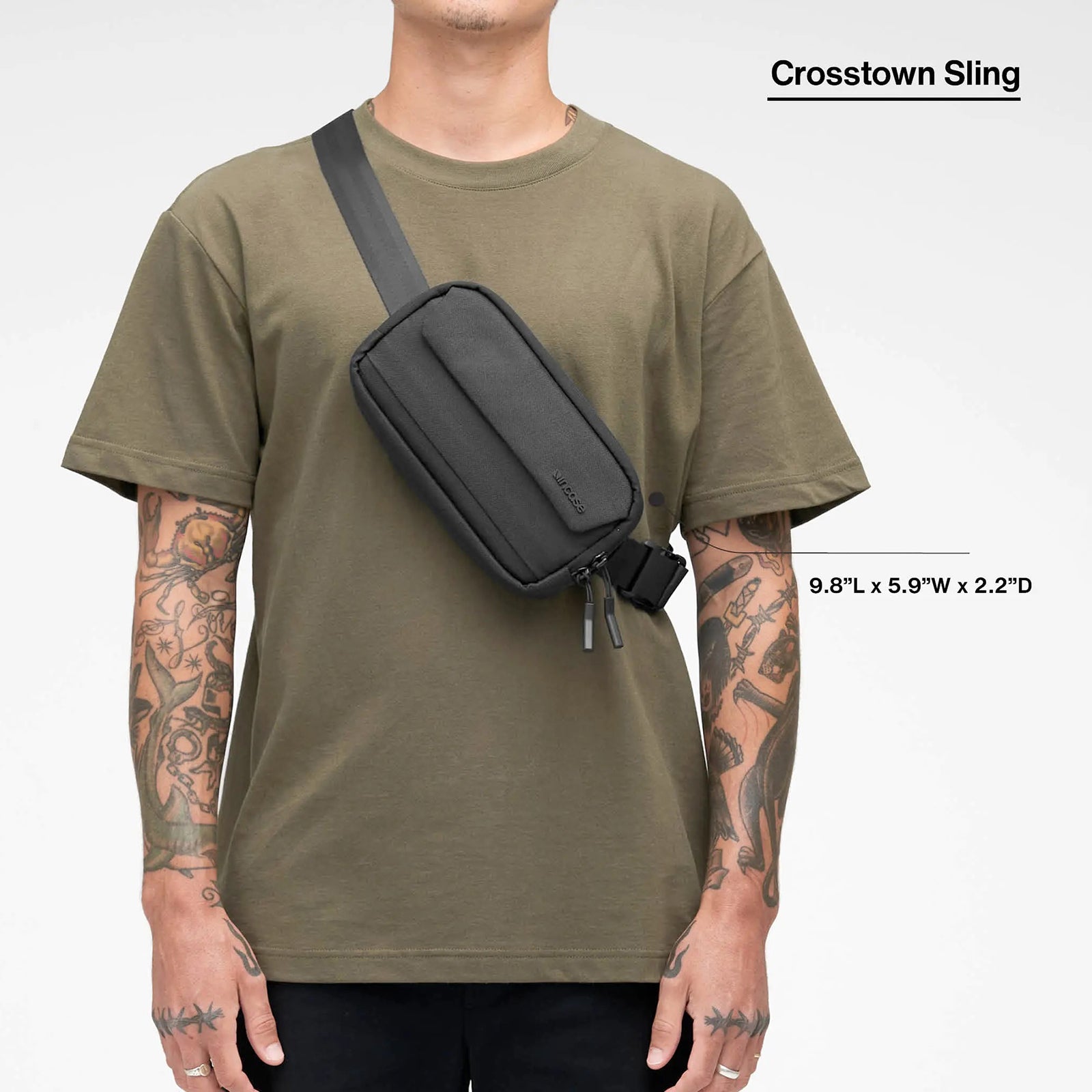 Front model view showing the Incase Crosstown Sling Black worn diagonally across the torso. Dimension graphics illustrate the compact size of approximately 9.8 inches long, 5.9 inches wide and 2.2 inches deep.