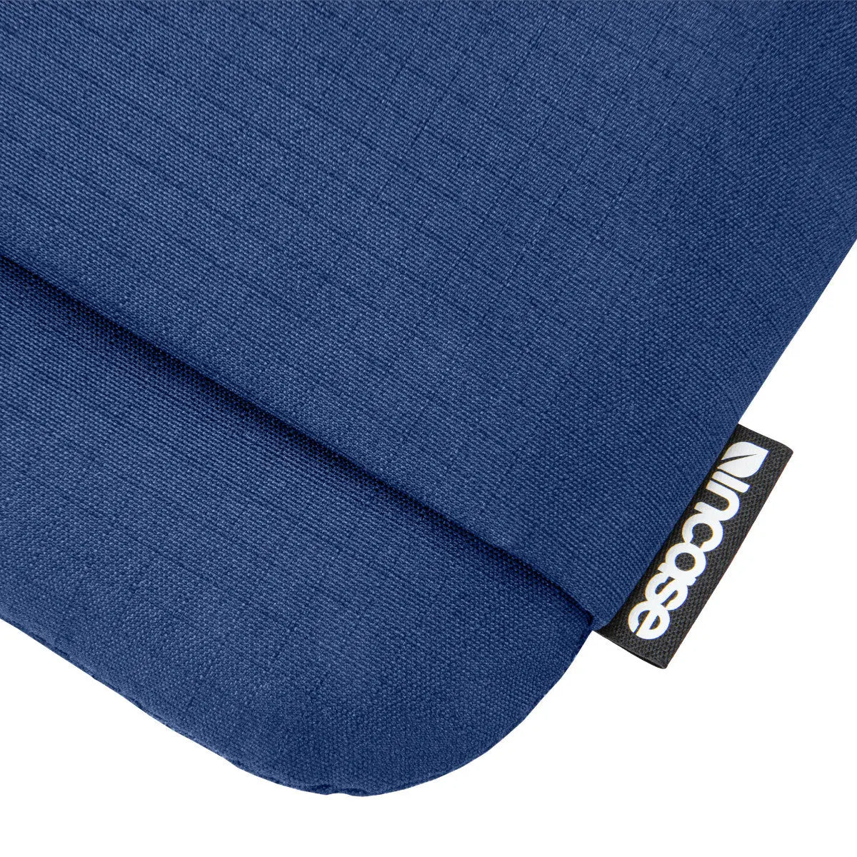 Close-up of the textured navy fabric and Incase label on the Go Sleeve for 14-inch laptops