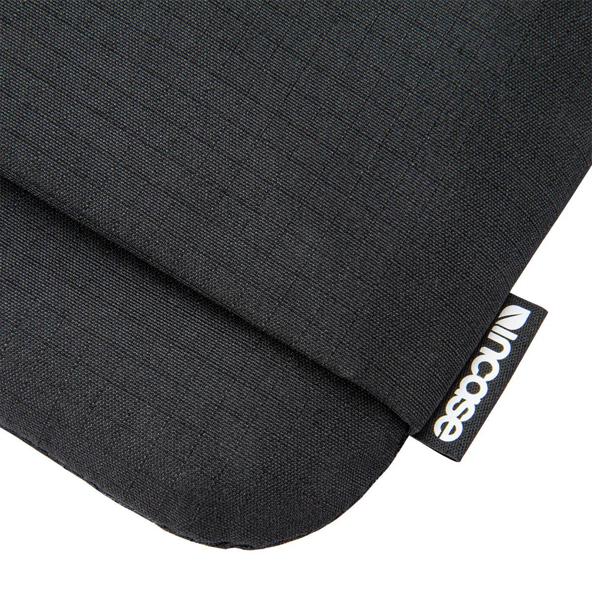 Close-up of the textured black fabric and Incase label on the Go Sleeve for 16-inch laptops