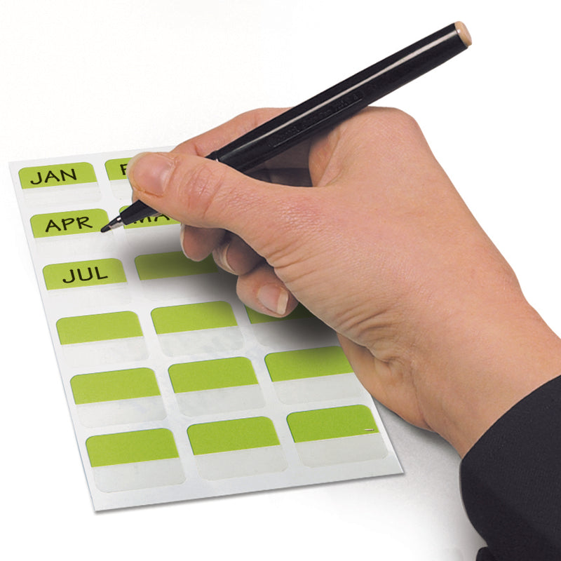 Hand writing month names such as JAN, APR and JUL on a sheet of green 3L index tabs