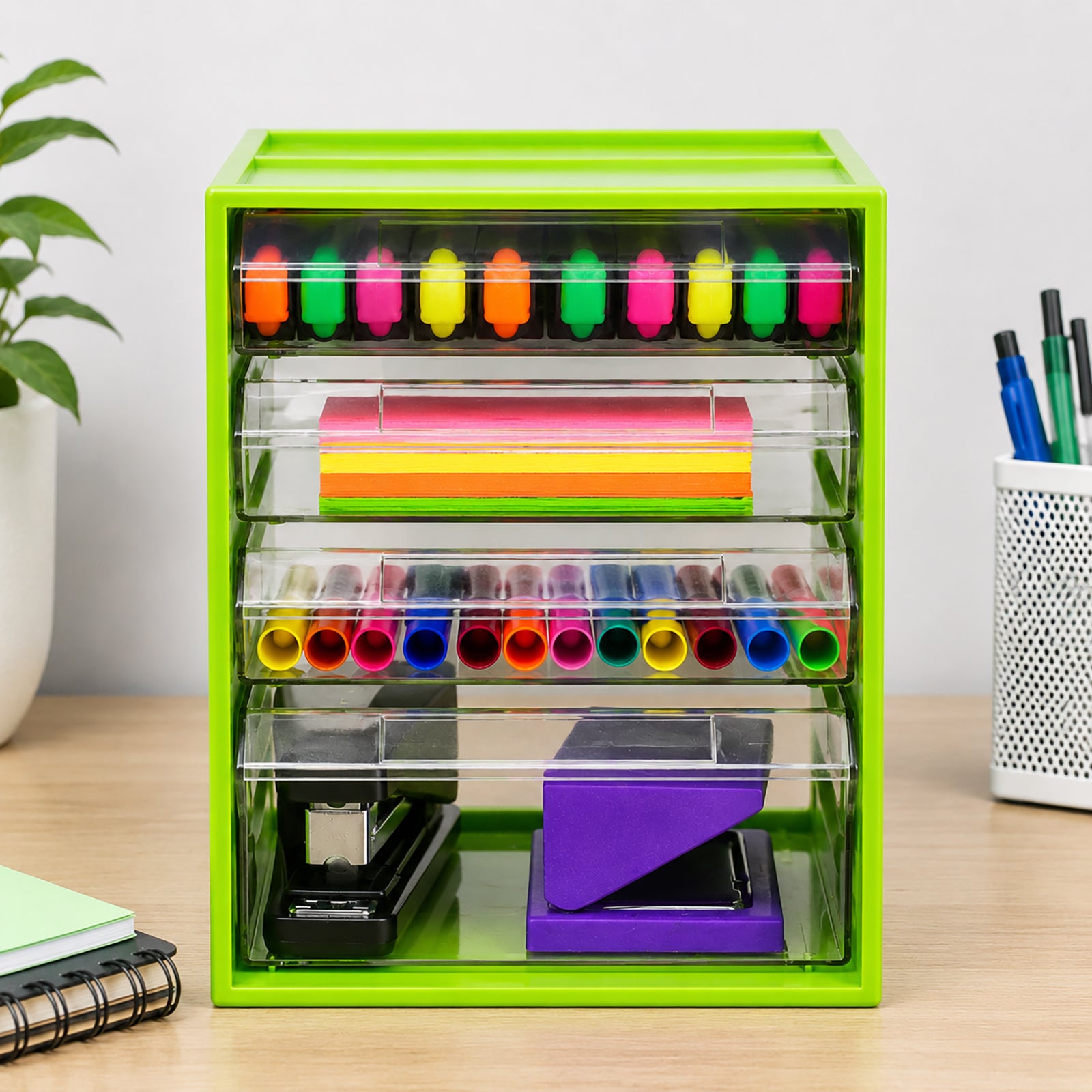 Front view of the Italplast Lime 4 Drawer Office Organiser showing its transparent storage compartments filled with colourful highlighters, sticky notes, pens and larger stapling tools. The clear drawer fronts make contents easy to identify, while the vivid green frame provides a fresh contemporary appearance for office, classroom or study storage.