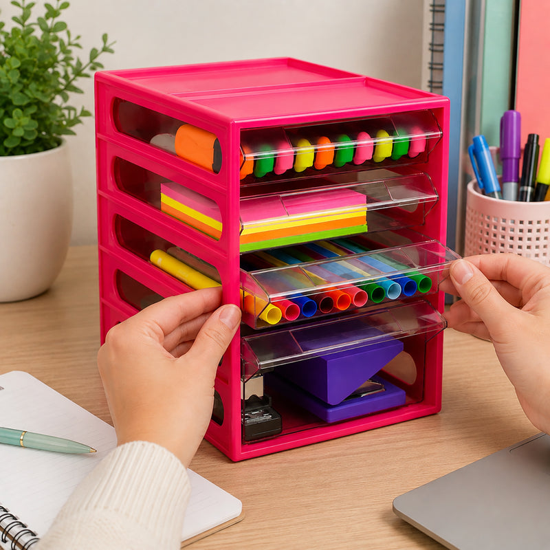 Italplast 4 Drawer Office Organiser in vibrant Watermelon on a timber workspace beside a notebook and laptop. Clear drawers display colourful highlighters, sticky notes, writing instruments and a purple stapler, while hands open one compartment to demonstrate convenient access and practical desktop stationery organisation.
