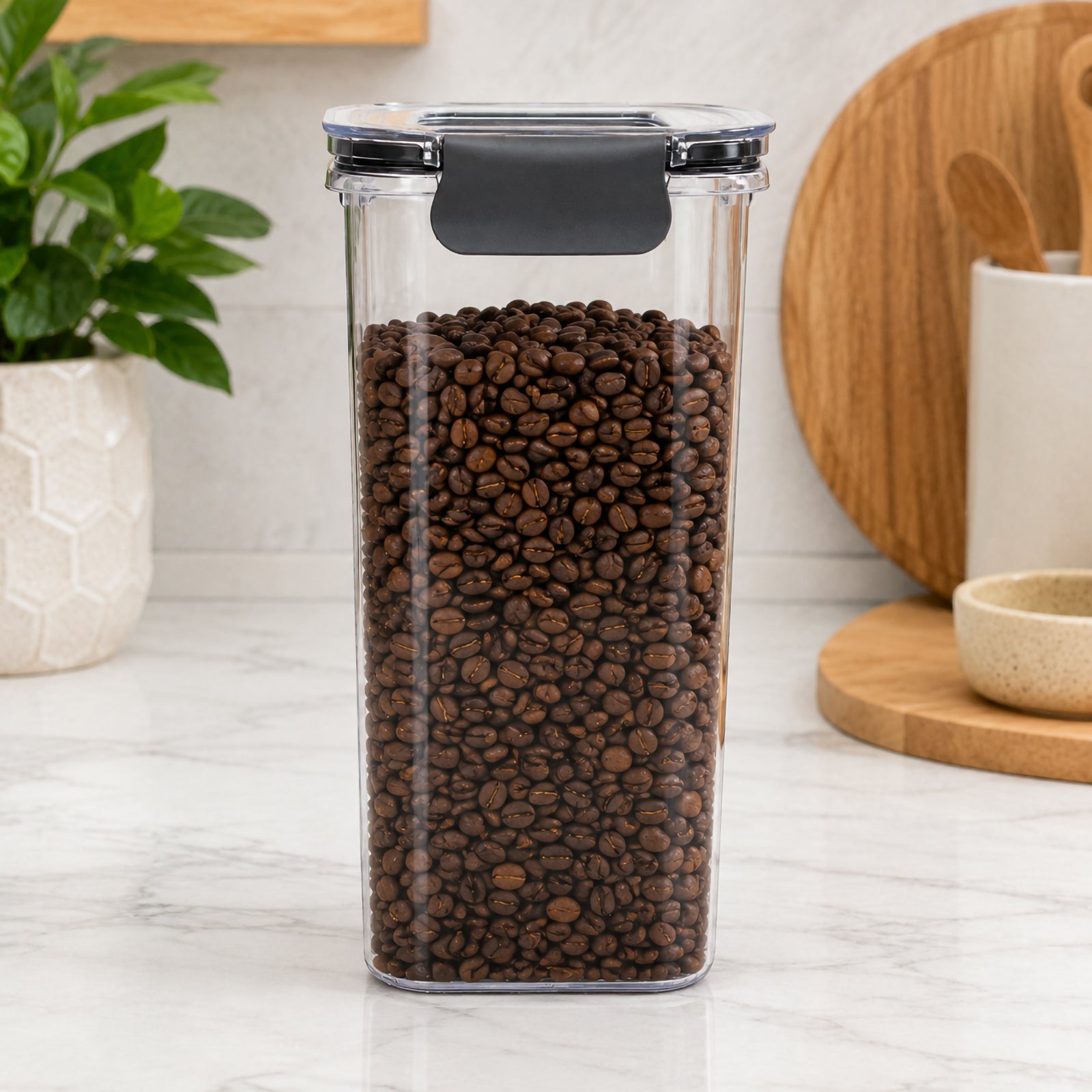 Front view of the Italplast 1.7 litre clear food container filled with roasted coffee beans on a kitchen benchtop. Its slim rectangular footprint and tall transparent body make the contents immediately visible, while the fitted clear lid and dark front locking closure highlight the secure snap lock storage design.