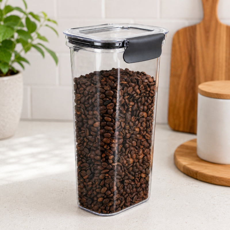 Angled view of the Italplast 1700ml Snap Lock Food Container storing coffee beans in a bright kitchen setting. The crystal clear body displays the contents from multiple sides, while the tall profile demonstrates how the container can maximise vertical pantry space without requiring a large shelf footprint.
