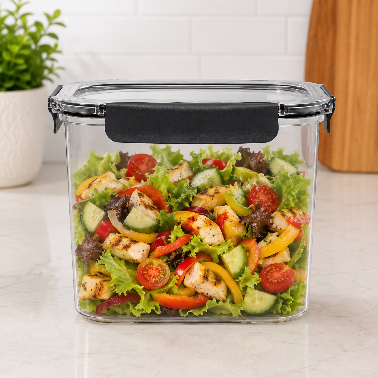 Front view of the Italplast 2850ml Snap Lock Food Container filled with a prepared chicken salad containing lettuce, cucumber, tomatoes and capsicum. Presented on a bright kitchen benchtop, the image highlights the containers tall rectangular profile, crystal clear visibility and prominent front closure, demonstrating useful capacity for prepared family meals and refrigerated food storage.