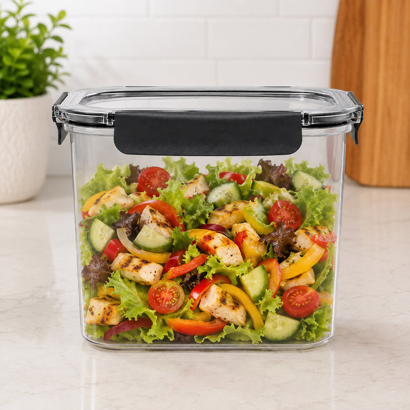 Front view of the Italplast 2850ml Snap Lock Food Container filled with a prepared chicken salad containing lettuce, cucumber, tomatoes and capsicum. Presented on a bright kitchen benchtop, the image highlights the containers tall rectangular profile, crystal clear visibility and prominent front closure, demonstrating useful capacity for prepared family meals and refrigerated food storage.