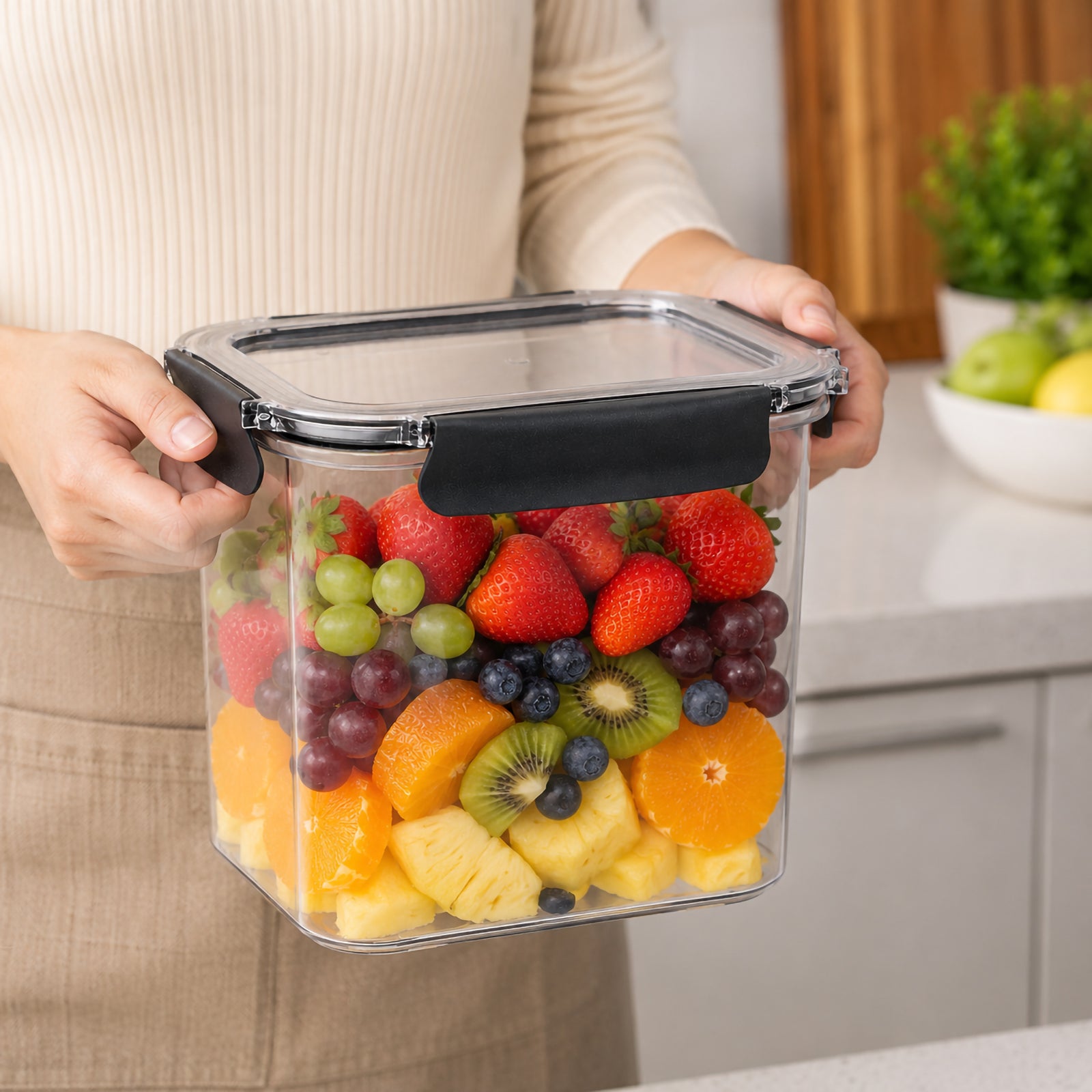Italplast 2850ml clear Snap Lock Food Container held securely in a kitchen and filled with colourful fresh fruit including strawberries, grapes, blueberries, kiwi, orange and pineapple. The image demonstrates the generous 2.85 litre capacity while clearly showing the transparent rectangular body, clear lid and contrasting dark snap lock closures designed for convenient everyday food storage.