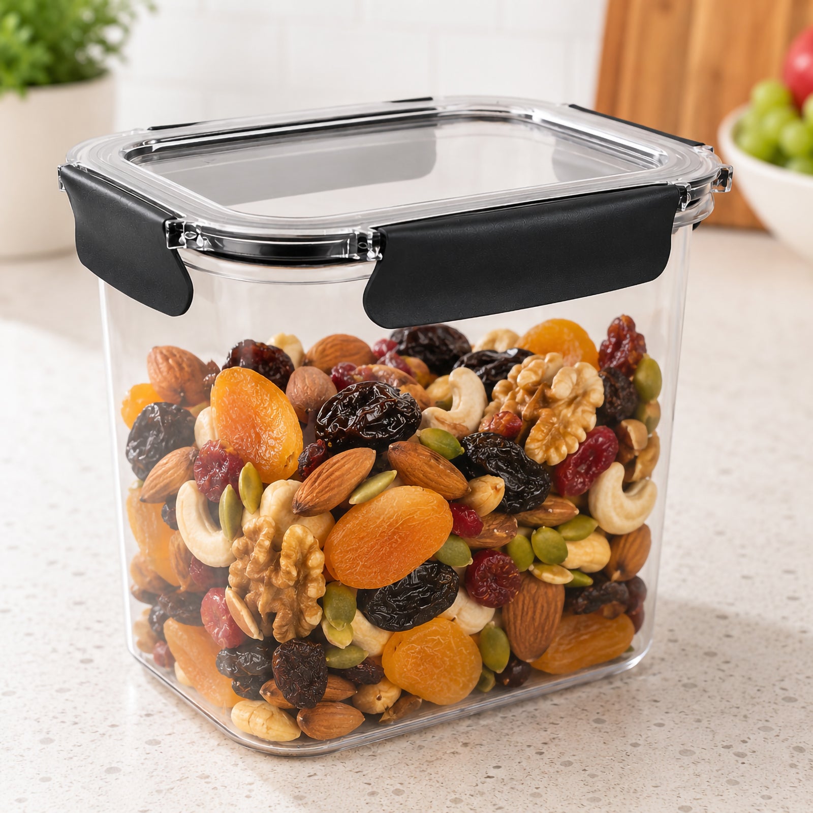 Angled kitchen view of the Italplast 2.85 litre clear food container filled with a mixture of almonds, cashews, walnuts, dried apricots, raisins, cranberries and seeds. The transparent walls make the pantry contents easy to identify while the clear lid and dark snap lock closures demonstrate a practical storage solution for bulk snacks and dry foods.