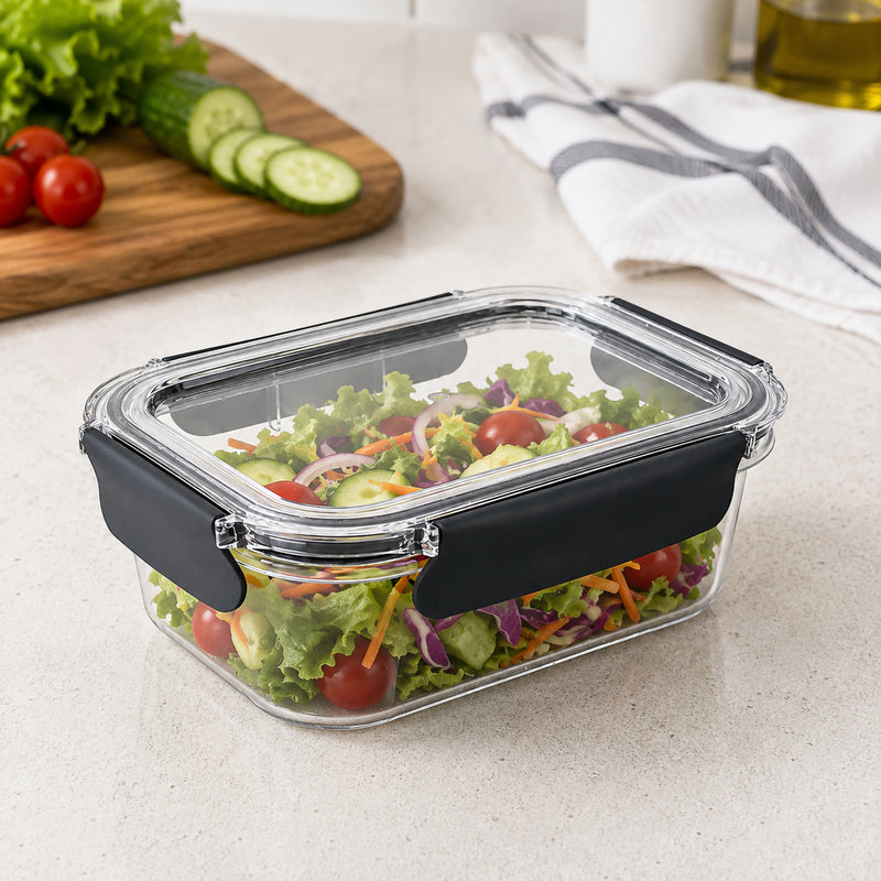 Angled kitchen view of the Italplast Snap Lock Food Container filled with lettuce, cucumber, tomato, carrot and cabbage. The clear lid and body provide excellent visibility, while black locking tabs secure the container around its perimeter, making it a practical option for fresh meal preparation, refrigerator organisation and portable lunch storage.