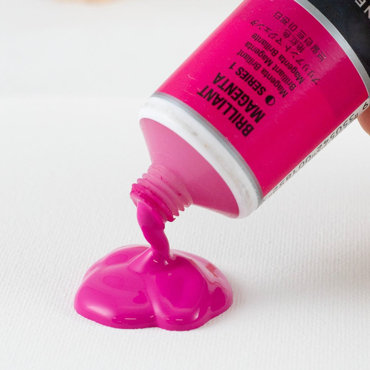 Brilliant Magenta acrylic pouring from an open Jo Sonja's 75ml tube onto white card