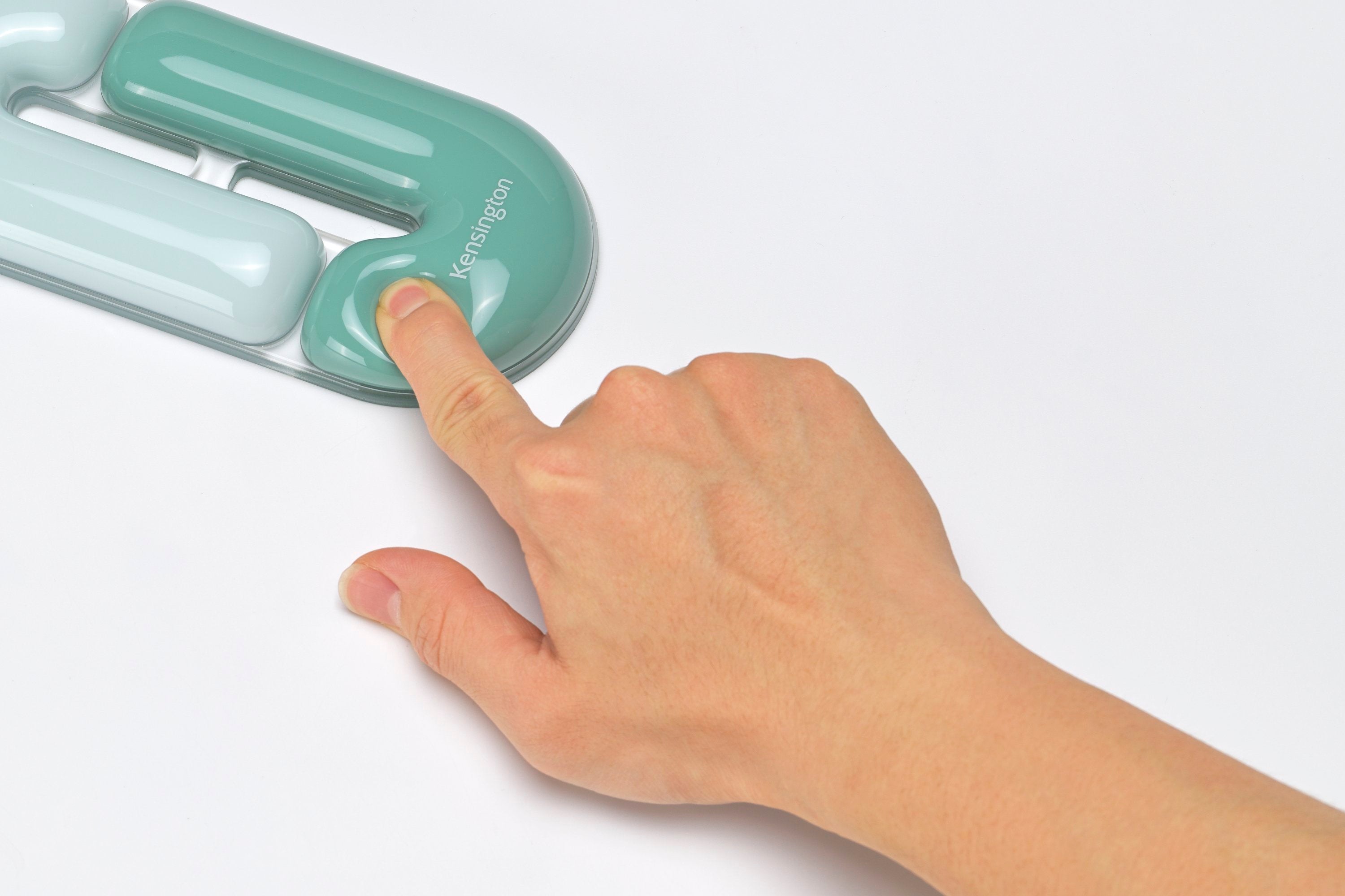 Hand pressing a green electronic device on a white background