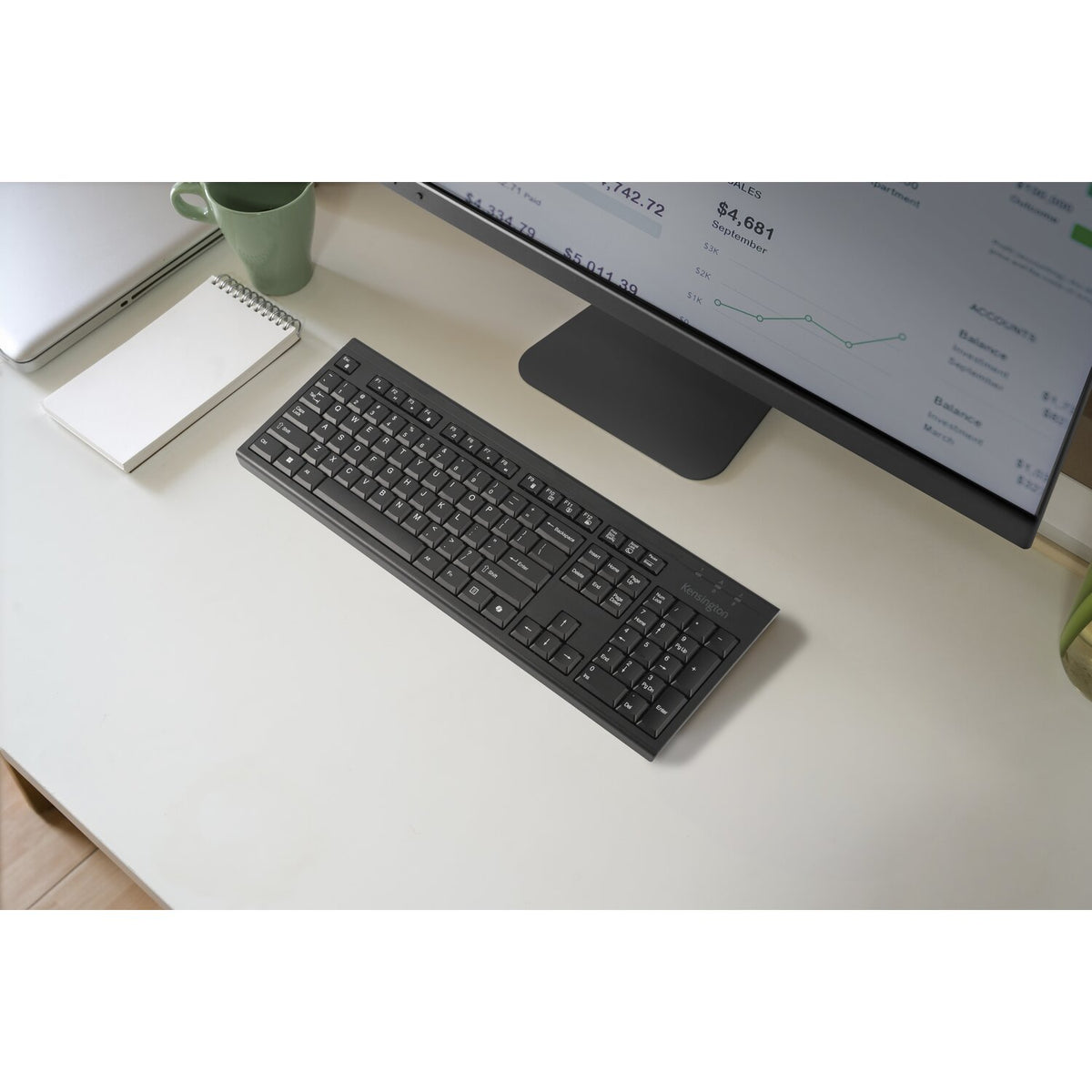 Kensington KB270 EQ Keyboard in black, overhead view on a desk in front of a monitor stand