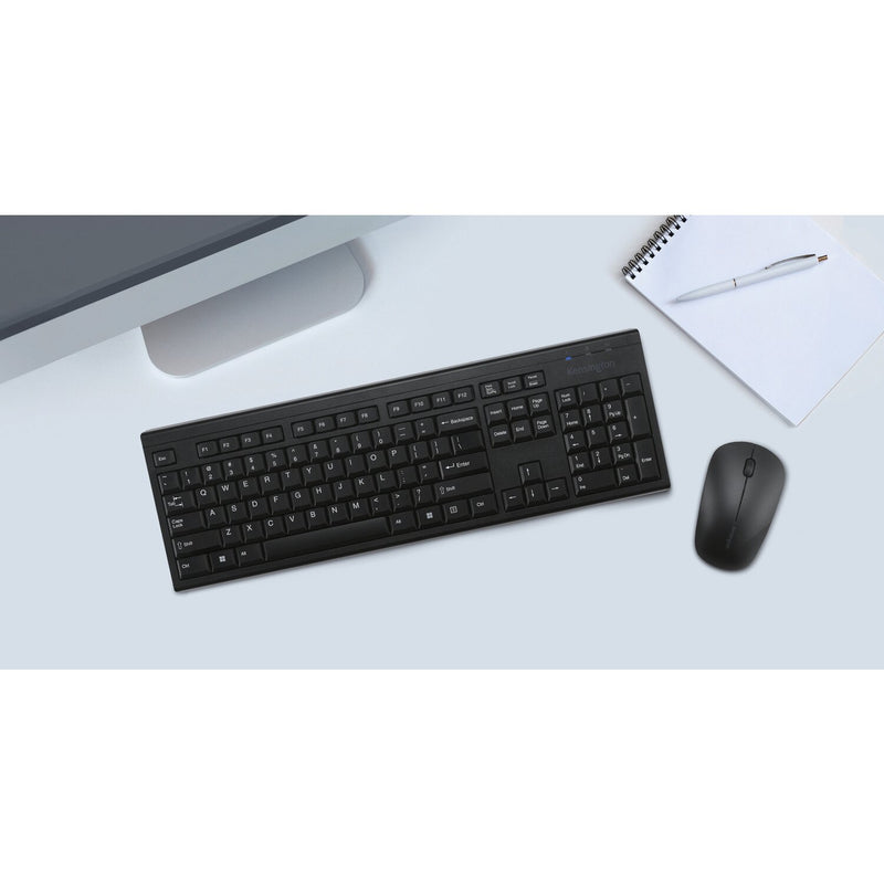 Kensington KM150 EQ Wireless Desktop Set on a light blue desk with a notebook and monitor stand