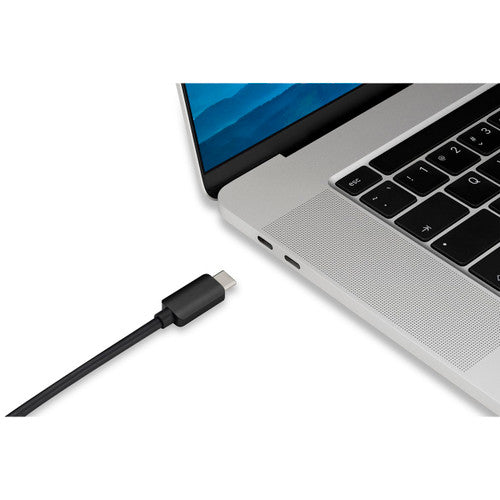 USB-C plug of the Kensington CV4200H adapter being lined up with the USB-C port on the side of a silver laptop
