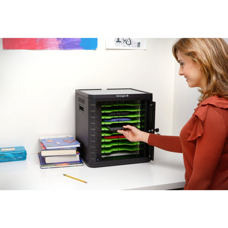 Teacher taking a tablet from a Kensington Charge and Sync cabinet sitting on a classroom bench