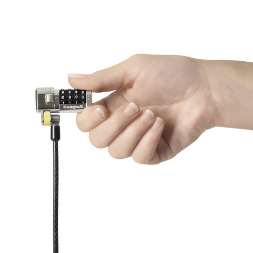 Hand holding the Kensington ClickSafe combination lock head by its cable, ready to click onto a laptop