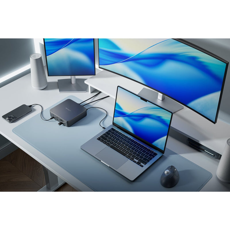 Kensington SD5010T5 dock on a white desk connected to a laptop and two large monitors in a bright office