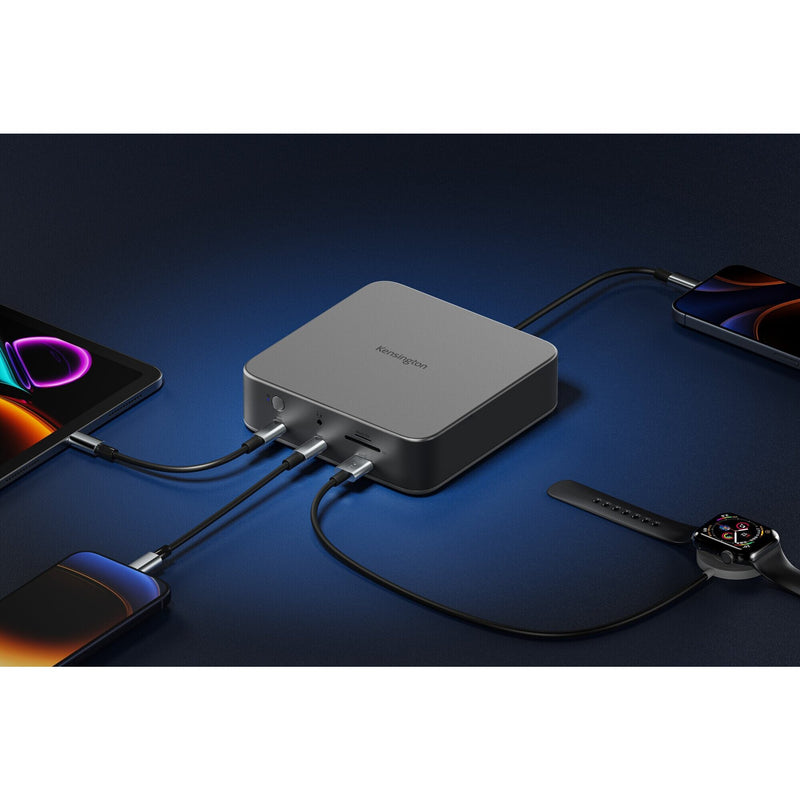 Kensington SD5010T5 docking station on a dark desk charging a phone, smartwatch and tablet while connected to a laptop