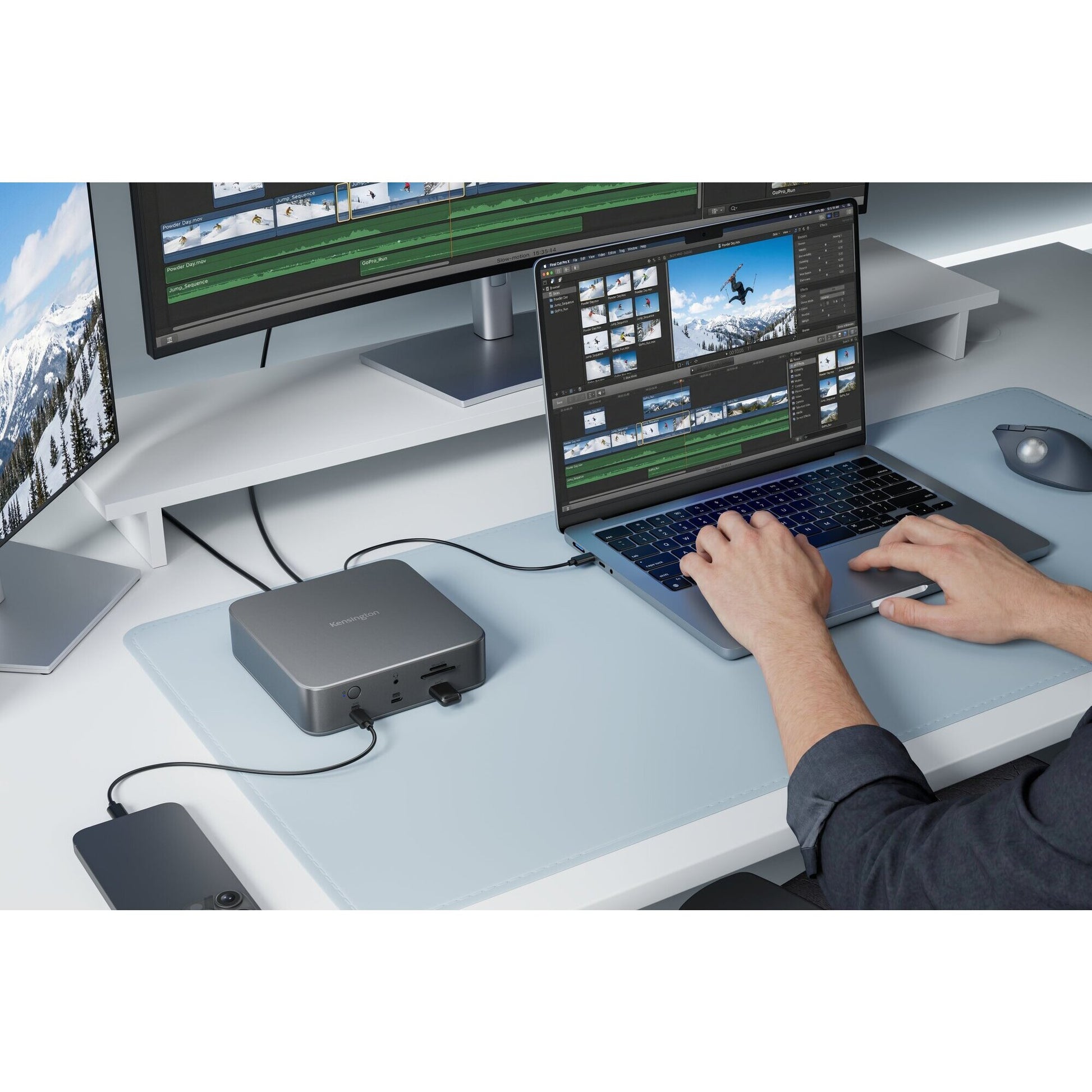 Video editor working on a laptop connected through the Kensington SD5010T5 dock to an external monitor showing an editing timeline