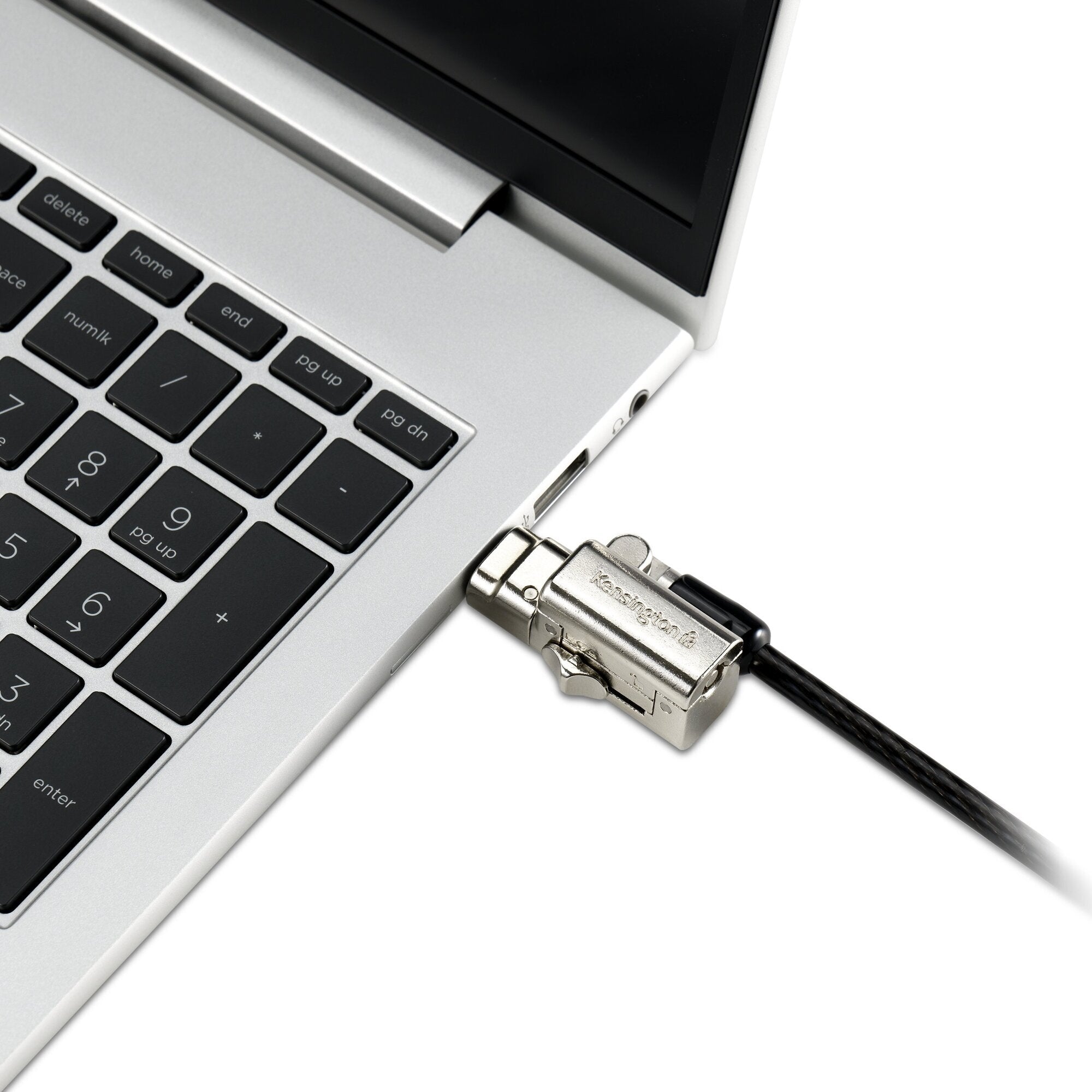 Kensington Universal 3-in-1 keyed laptop lock shown in use, the black lock head engaged in a device security slot with the cable running away to an anchor point